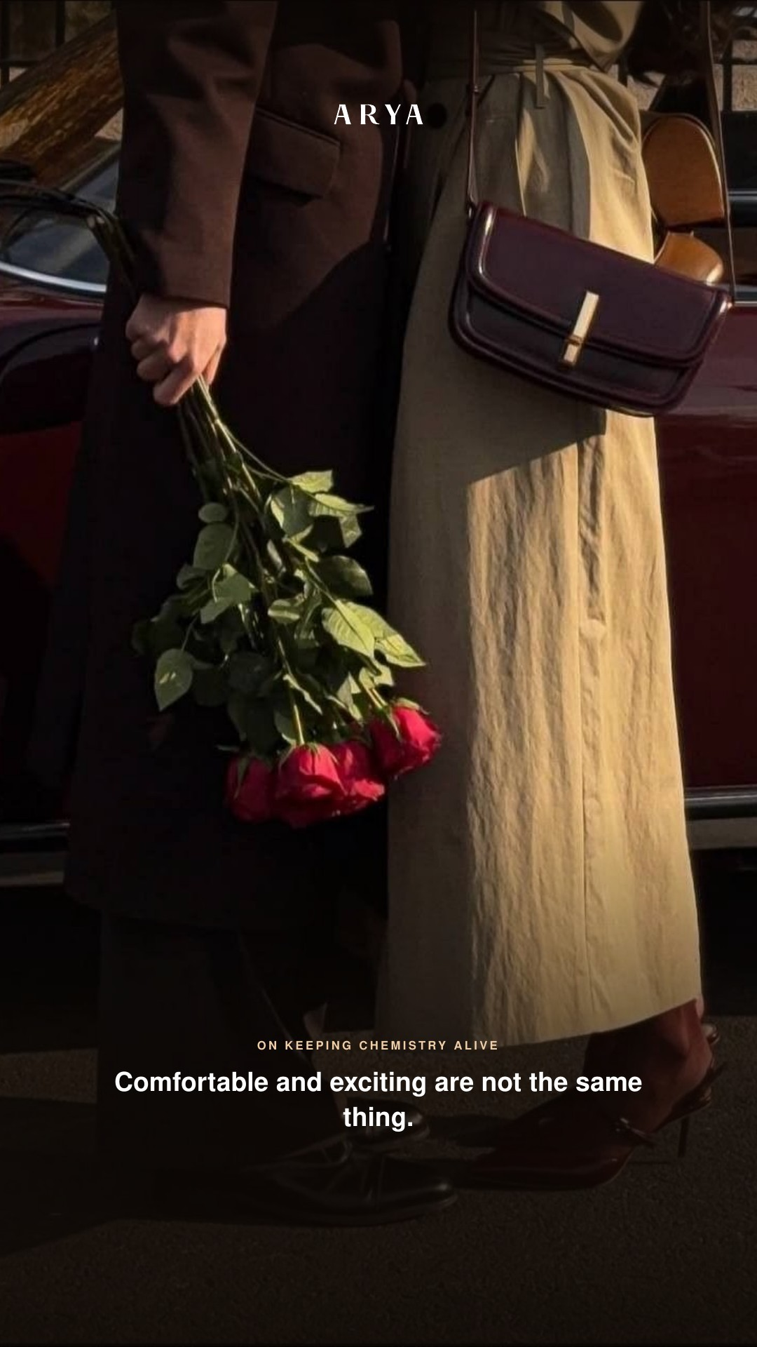 Couple beside a car holding roses. Comfortable and exciting are not the same thing.